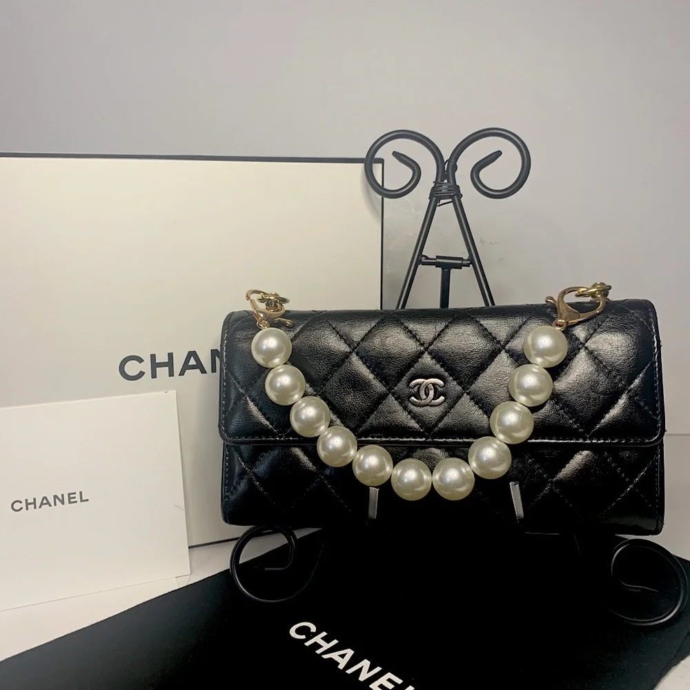 CHANEL Black Quilted Lambskin Crossbody with Gold Chain & Tassel Accent